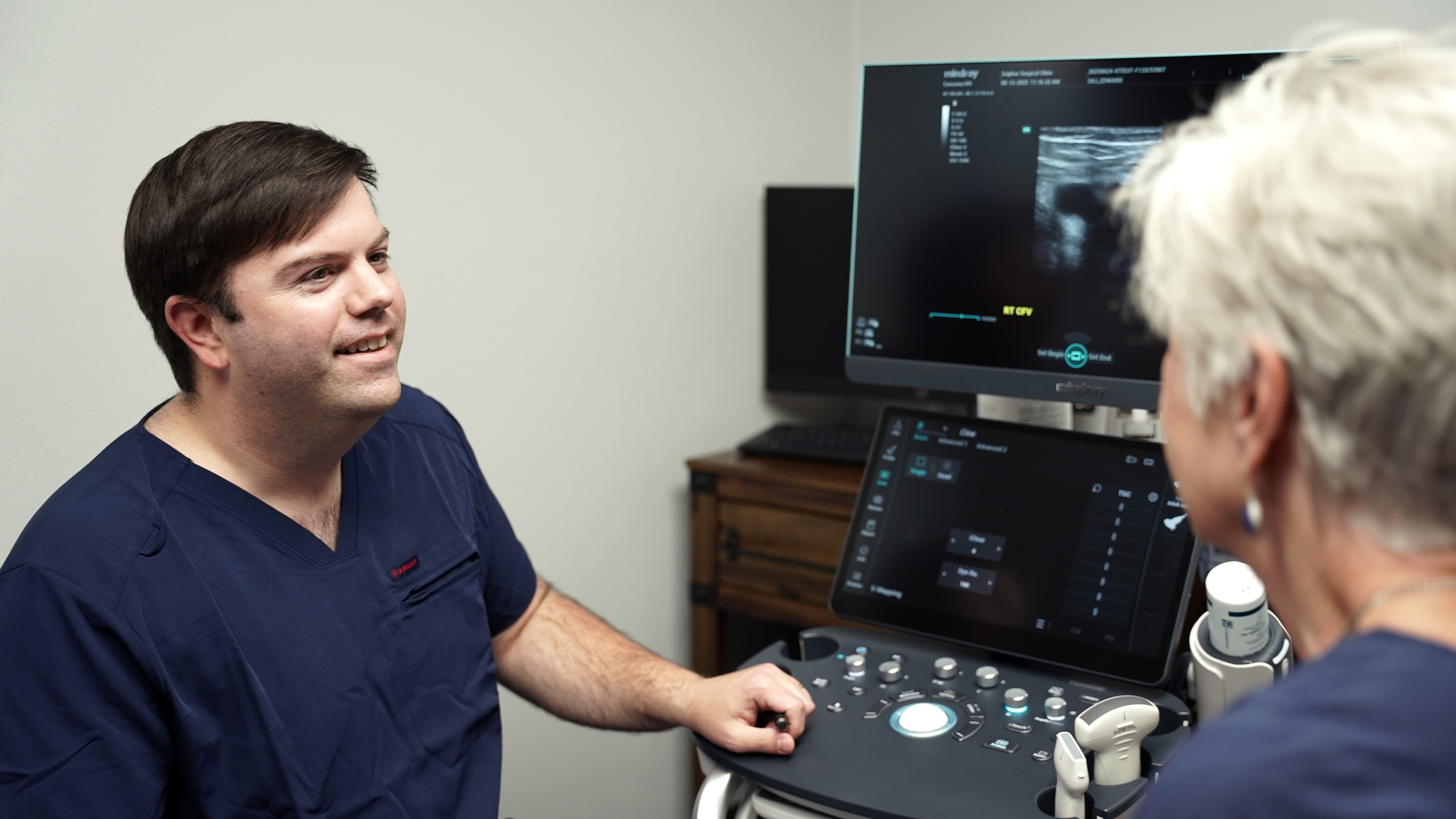 A Sulphur Surgical Clinic surgeon with a patient during an ultrasound exam